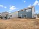 Spacious backyard featuring a fire pit area and a sliding glass door entrance at 3038 Lydney Cir, Waxhaw, NC 28173