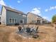 Cozy backyard with a fire pit surrounded by chairs, perfect for entertaining guests at 3038 Lydney Cir, Waxhaw, NC 28173