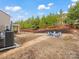 Landscaped backyard features a fire pit area with chairs, perfect for outdoor gatherings at 3038 Lydney Cir, Waxhaw, NC 28173