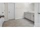 Bright bathroom featuring light grey flooring, white walls, and a vanity with a countertop at 3038 Lydney Cir, Waxhaw, NC 28173