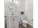 Stylish half-bath with modern fixtures, shiplap walls, and a round mirror at 3038 Lydney Cir, Waxhaw, NC 28173