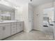 Bathroom featuring a double sink vanity, white quartz countertop, grey shaker cabinets and tile flooring at 3038 Lydney Cir, Waxhaw, NC 28173