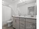 Bathroom with double sink vanity, white quartz countertop, grey shaker cabinets and tile flooring at 3038 Lydney Cir, Waxhaw, NC 28173