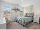 Inviting bedroom with a calming color scheme, two windows, and a bedside table at 3038 Lydney Cir, Waxhaw, NC 28173