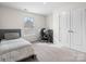 Bedroom featuring neutral carpet, a twin sized bed, a double door closet and a window at 3038 Lydney Cir, Waxhaw, NC 28173