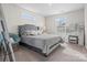Comfortable bedroom with plush carpet, large windows, and a cozy vanity area at 3038 Lydney Cir, Waxhaw, NC 28173