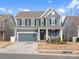 Charming two-story home with blue siding, black shutters, well-manicured lawn, and inviting front porch at 3038 Lydney Cir, Waxhaw, NC 28173
