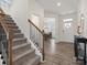 Open foyer featuring hardwood floors, staircase, and view into the dining room at 3038 Lydney Cir, Waxhaw, NC 28173