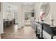 Elegant foyer with wood floors, a modern console table, and a view into the dining room at 3038 Lydney Cir, Waxhaw, NC 28173