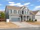 Charming two-story home with a well-manicured lawn, covered porch, and attached garage at 3038 Lydney Cir, Waxhaw, NC 28173