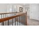 Upstairs hallway featuring neutral carpet, white walls, and a decorative wrought iron wall hanging at 3038 Lydney Cir, Waxhaw, NC 28173