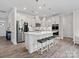 Bright kitchen features white cabinets, stainless steel appliances, a large island with bar seating, and pendant lighting at 3038 Lydney Cir, Waxhaw, NC 28173
