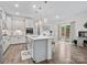 Spacious kitchen with island seating, white cabinets, and a breakfast area leading to the backyard at 3038 Lydney Cir, Waxhaw, NC 28173