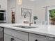 Close-up of a kitchen island sink, quartz countertop, and stylish faucet in a well-lit space at 3038 Lydney Cir, Waxhaw, NC 28173