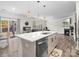 Bright kitchen featuring an island, stainless steel dishwasher, and easy access to the outdoor patio at 3038 Lydney Cir, Waxhaw, NC 28173