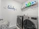 Laundry room featuring LG washer and dryer set, wire shelf, tile flooring, and modern laundry decor at 3038 Lydney Cir, Waxhaw, NC 28173