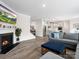 Open living room with hardwood floors, fireplace, and views into the dining area and kitchen at 3038 Lydney Cir, Waxhaw, NC 28173