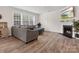 Comfortable living room featuring hardwood floors, fireplace, large windows, and modern decor at 3038 Lydney Cir, Waxhaw, NC 28173