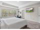 Spacious main bedroom featuring a large window, neutral carpet, and a trey ceiling at 3038 Lydney Cir, Waxhaw, NC 28173