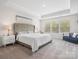 Main bedroom with trey ceiling, neutral walls, neutral carpet, and a bench under a window at 3038 Lydney Cir, Waxhaw, NC 28173