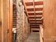 Unfinished basement space with exposed brick and wood stairs at 3087 E Nc Hwy 150 Hwy, Lincolnton, NC 28092