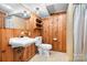 Bathroom featuring wood paneling, toilet, sink, mirror and recessed lighting at 3087 E Nc Hwy 150 Hwy, Lincolnton, NC 28092
