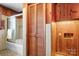 Bathroom features a tub with glass doors, wood cabinets, and tile flooring at 3087 E Nc Hwy 150 Hwy, Lincolnton, NC 28092