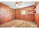 Bedroom with wood paneling, a ceiling fan, built-in shelves, and closet at 3087 E Nc Hwy 150 Hwy, Lincolnton, NC 28092