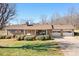 Charming brick home featuring a manicured lawn and inviting covered front porch at 3087 E Nc Hwy 150 Hwy, Lincolnton, NC 28092