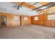 Unfinished garage featuring wood paneling and a door leading to the exterior at 3087 E Nc Hwy 150 Hwy, Lincolnton, NC 28092