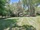 Beautifully maintained lawn with neatly mowed stripes surrounded by mature trees offering shade and privacy at 3600 Carmel Rd, Charlotte, NC 28226