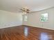 Spacious bedroom with hardwood floors, two windows, and ceiling fan at 3600 Carmel Rd, Charlotte, NC 28226