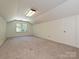 Lofted bonus room with carpet, window, and ample natural light at 3600 Carmel Rd, Charlotte, NC 28226