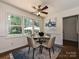Bright dining area features modern lighting fixture and large windows overlooking the outdoor patio at 3600 Carmel Rd, Charlotte, NC 28226
