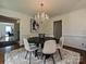 Bright dining room features modern chandelier, round table, and a plush rug at 3600 Carmel Rd, Charlotte, NC 28226