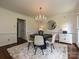 Chic dining room with a modern chandelier, round table, and neutral decor at 3600 Carmel Rd, Charlotte, NC 28226