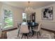Bright dining room features modern chandelier, round table, and a plush rug at 3600 Carmel Rd, Charlotte, NC 28226