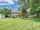 Charming two-story home with classic curb appeal, a lush lawn, and mature trees in a desirable neighborhood at 3600 Carmel Rd, Charlotte, NC 28226