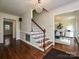 Elegant foyer featuring hardwood floors, staircase, chandelier, and views into other rooms at 3600 Carmel Rd, Charlotte, NC 28226