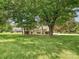 Lush green lawn and mature trees create a serene and inviting landscape around the house at 3600 Carmel Rd, Charlotte, NC 28226