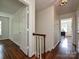 Hallway with hardwood floors and natural lighting leading to the bedrooms at 3600 Carmel Rd, Charlotte, NC 28226