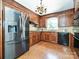 Kitchen featuring stainless steel refrigerator and wood cabinetry at 3600 Carmel Rd, Charlotte, NC 28226