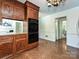 Kitchen with wood cabinetry, double ovens, and hardwood-look flooring at 3600 Carmel Rd, Charlotte, NC 28226
