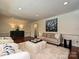 Bright living room with hardwood floors features neutral furnishings and modern art at 3600 Carmel Rd, Charlotte, NC 28226