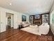 Cozy living room features brick fireplace, built-in shelves, and hardwood floors at 3600 Carmel Rd, Charlotte, NC 28226