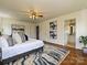 Spacious main bedroom featuring hardwood floors, a ceiling fan, and a full bathroom at 3600 Carmel Rd, Charlotte, NC 28226