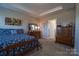 This bedroom features a tray ceiling, bed, and wooden dressers for storage at 3624 County Down Ave # 5-14, Kannapolis, NC 28081