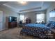 This room features a bed with a nightstand, desk, dresser, and two windows at 3624 County Down Ave # 5-14, Kannapolis, NC 28081