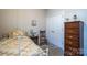 Cozy bedroom features a patterned bedspread, wooden dresser and a closet for ample storage at 3624 County Down Ave # 5-14, Kannapolis, NC 28081