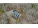 An aerial view of a charming home with a cozy deck surrounded by lush trees and a private driveway at 369 Falcon Dr, Concord, NC 28025